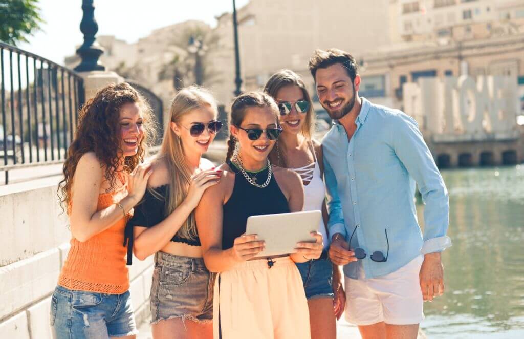 Grouped gathered together watching a viral video