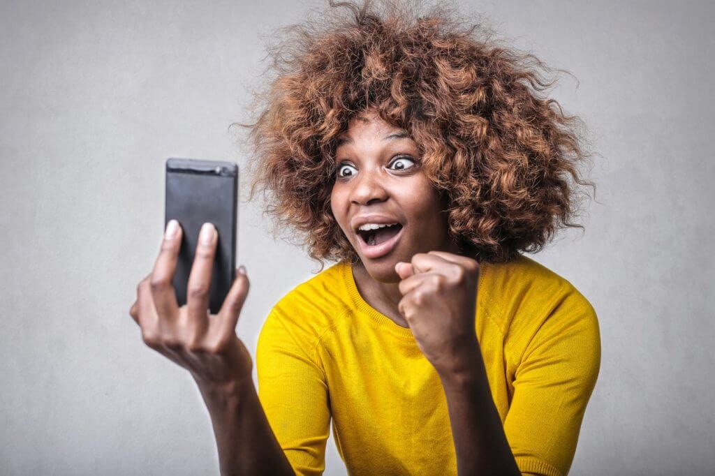 Woman reacting to a viral video on her cell phone